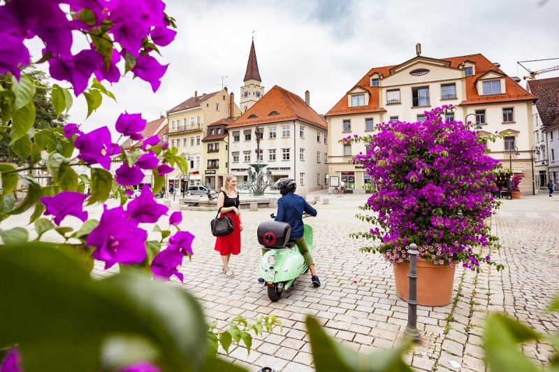 Frau und Rollerfahrer auf dem Ehinger Markplatz